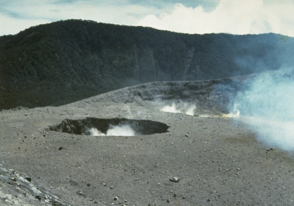Plumes rise from two small craters near the center of Marapi's broad E-W-trending summit. The background ridge in the shadow is the eastern rim of a larger crater, Kebun Bungo. Photo by J. Mataheumual, 1978 (Volcanological Survey of Indonesia).
