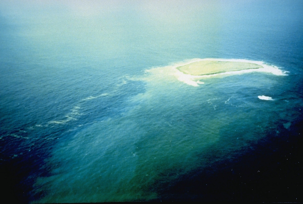 This photo shows a new island at the Fukutoku-Oka-no-ba submarine volcano on 28 January 1986. It was first seen on 20 January, four days after fishing boats observed an eruption plume rising from the ocean. The island reached a maximum size of 400 x 600 m, with a height of 15 m. By 22 January explosive activity had ceased, and the island was completely eroded away by 8 March. Photo by G. Iwashita, 1986 (Japan Meteorological Agency).