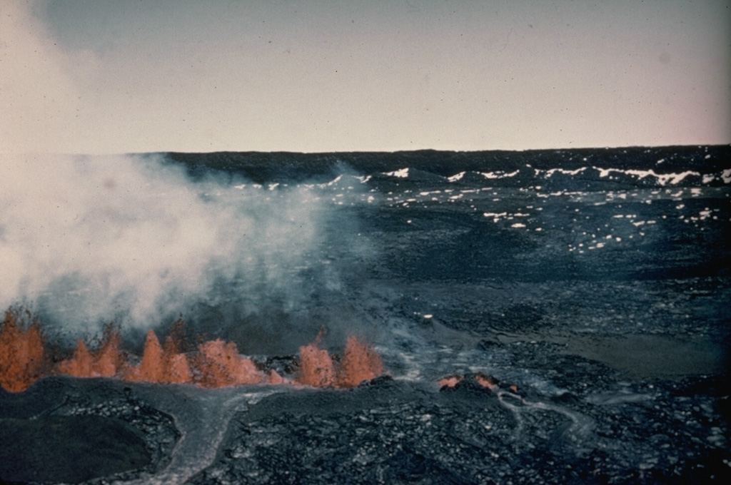 A line of lava fountains across the floor of Moku‘āweoweo caldera is seen from the western Mauna Loa caldera rim on 9 April 1940, two days after the start an eruption at the summit and upper SW flank. The fissure erupted in the SW portion of the caldera and propagated a total distance of 6 km across the caldera and down the SW rift zone. During the course of the eruption lava flows covered two-thirds of the caldera floor. Photo by G.O. Fagerlund (U.S. Geological Survey).