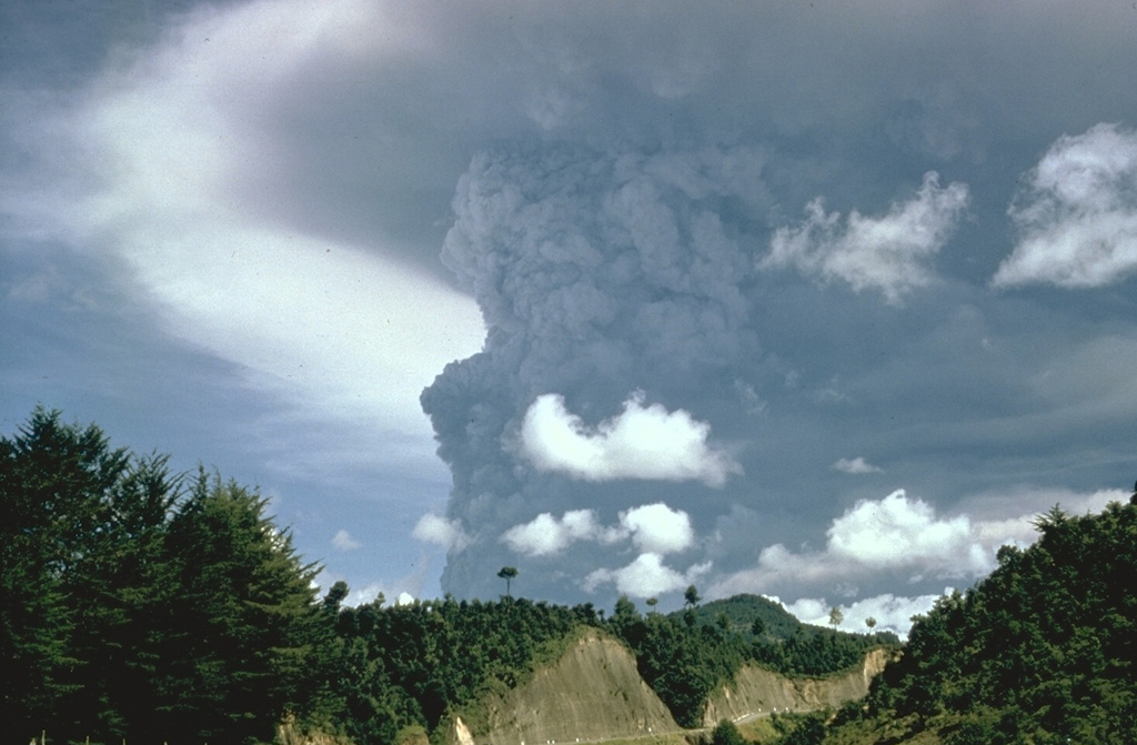 Following mild eruptions that began on 7 February 1966, a powerful eruption in April produced this ash plume that towers above the summit (not visible in this view). Major eruptions during 20 April to 1 May were accompanied by pyroclastic flows and lava flows. Photo by Bill Rose, 1966 (Michigan Technological University).