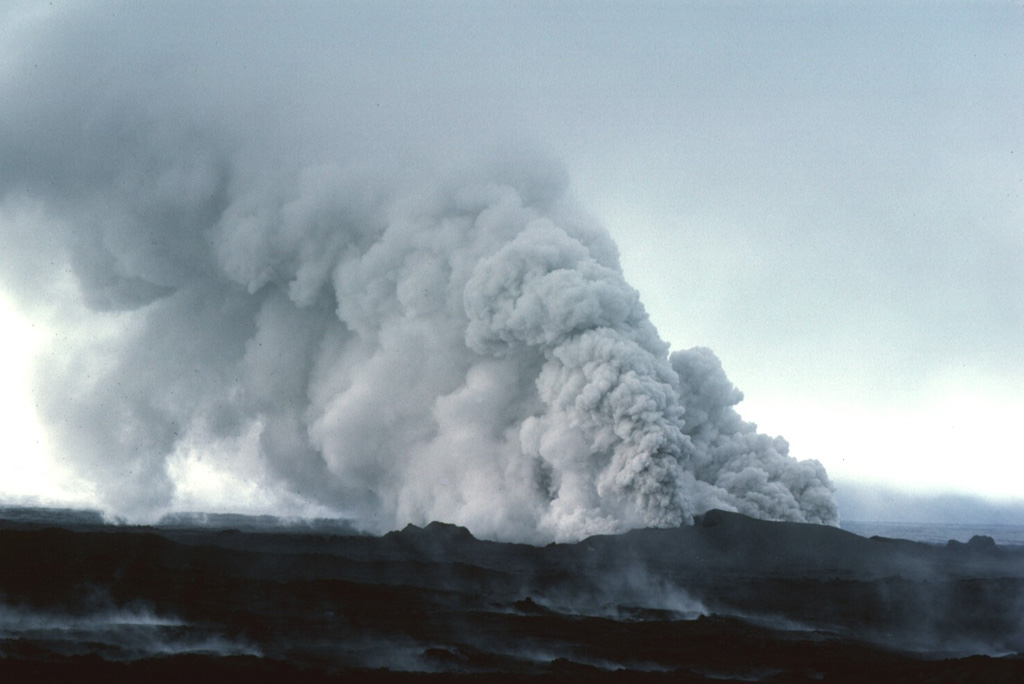 On 13 September 1984 groundwater gained access to the eruptive fissure at Krafla, producing these clouds of steam and ash. The two-week eruption, which began on 4 September 1984, was dominantly effusive, and produced 0.12 km3 of lava flows from an 8.5-km-long fissure. Photo by Michael Ryan, 1984 (U.S. Geological Survey).