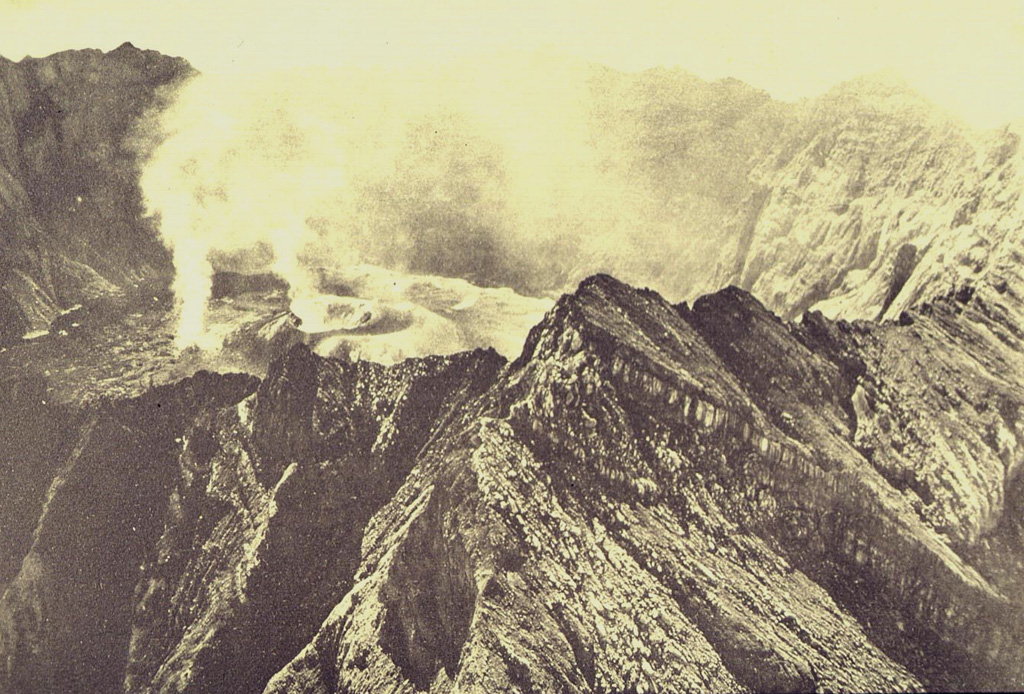 Gas-and-steam plumes rise above the 1913 crater in this August 1922 aerial photo of Raung's summit caldera, taken from the NW. A lava flow covers the caldera floor to the left of the 1913 cone. Photo published in Taverne, 1926 