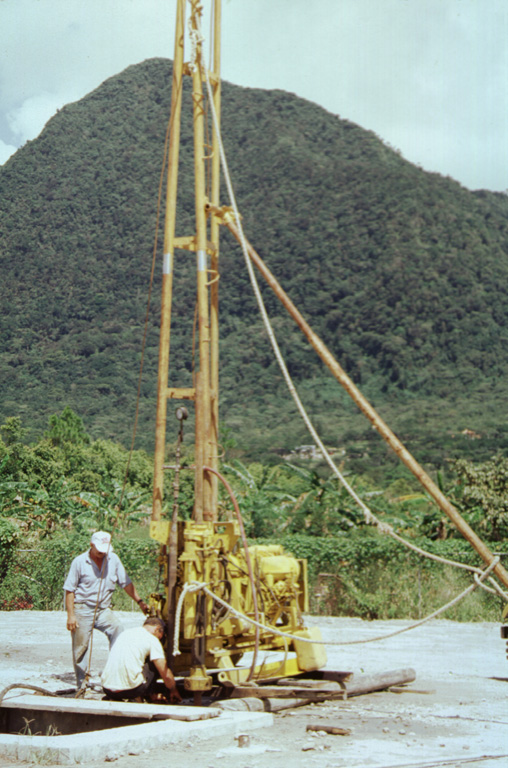 This drill rig on the floor of El Valle de Antón caldera is part of a major geothermal exploration program at El Valle volcano. In the background to the north is Cerro Gaital, the highest of three post-caldera lava domes along the northern caldera rim.  Photo by Paul Kimberly, 1998 (Smithsonian Institution).