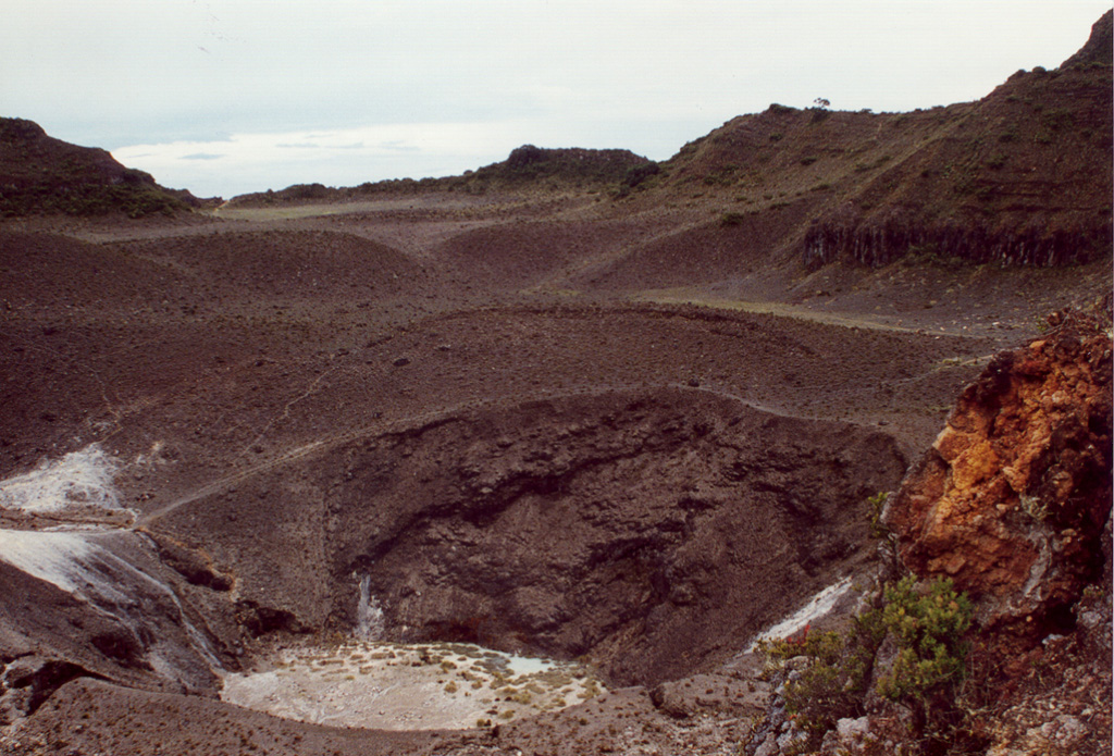 The 50-m-deep Turrialba central crater (seen here looking NE) and the SW crater were the source of a large eruption in 1866. Phreatomagmatic that year produced ashfall in Costa Rica's Central Valley for four days in January, and three days in February. Ash fell as far as Puntarenas and El Realejo in Nicaragua. Pyroclastic surges traveled more than 4 km, and small lahars traveled down the Río Aquiares and presumably other valleys. Photo by José Enrique Valverde Sanabria, 1996 (courtesy of Eduardo Malavassi, OVSICORI-UNA).
