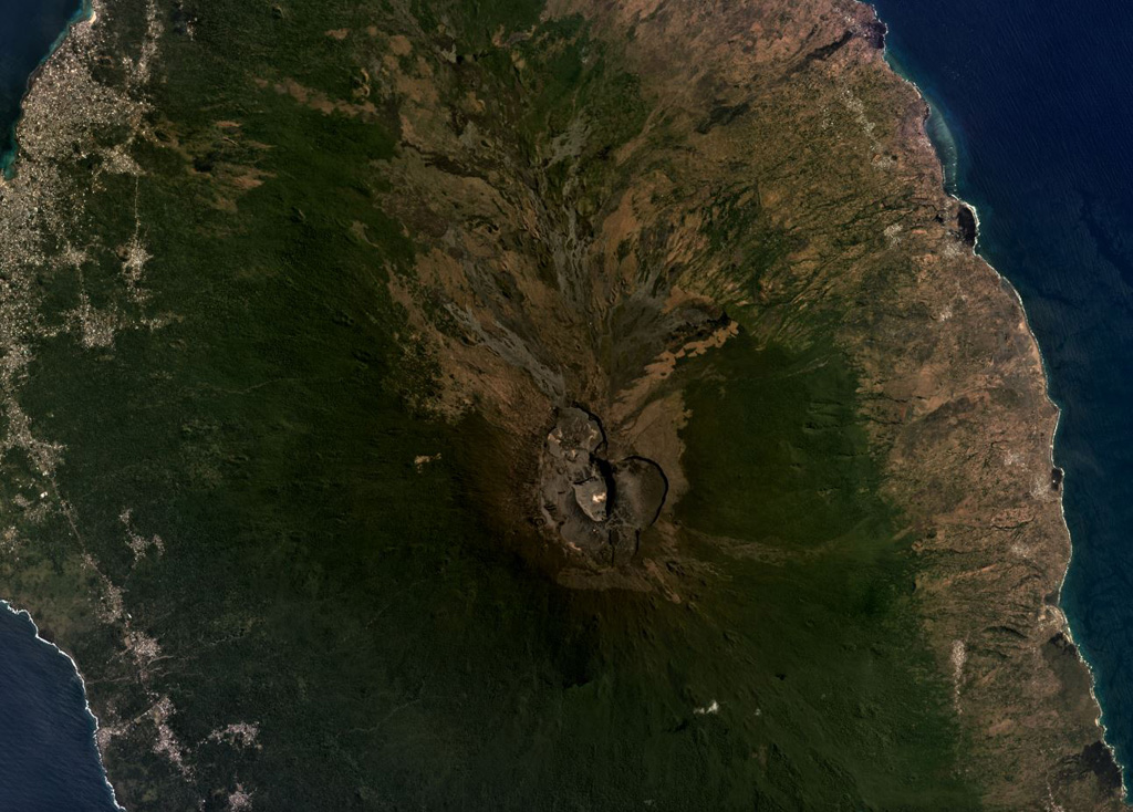 Karthala shield volcano forms the southern two-thirds of Grand Comore Island, NW of Madagascar in the Indian Ocean. The summit caldera is near the center of this August 2019 Planet Labs satellite image monthly mosaic (N is at the top; this image is approximately 25 km across). Lava flows reach the ocean on both sides from summit and flank vents, and rift zones propogate to the SE and NW from the caldera. Satellite image courtesy of Planet Labs Inc., 2019 (https://www.planet.com/).