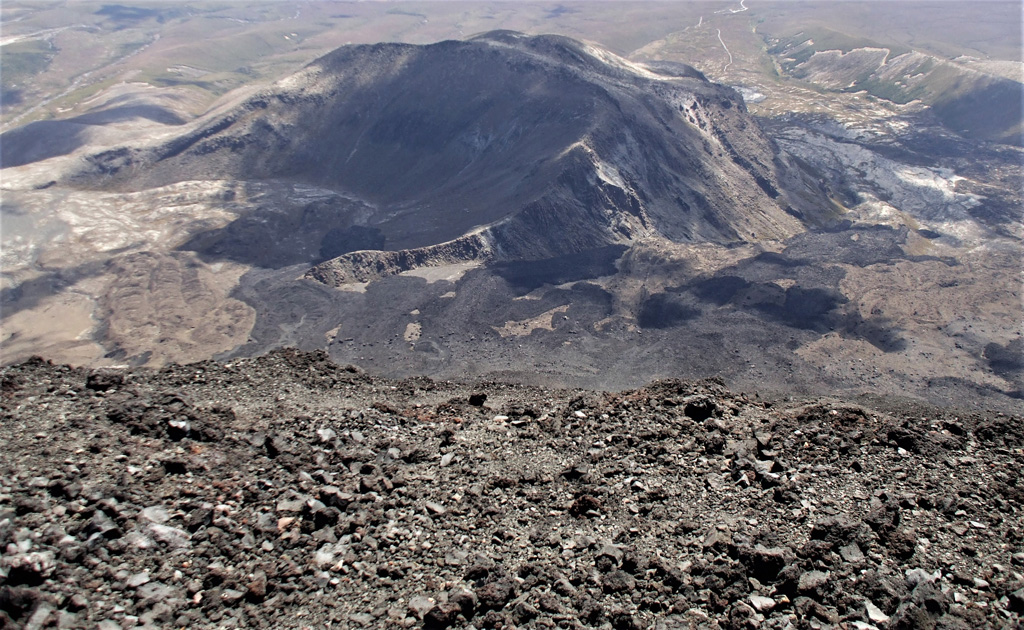 This view from the Ngauruhoe summit to below the SW flank shows the lava flows emplaced during the 1954-55 eruption, down the Tongariro flank and around the eroded Pukekaikiore cone. They overlie older lava flows from the same vent. Photo by Janine Krippner, 2008.
