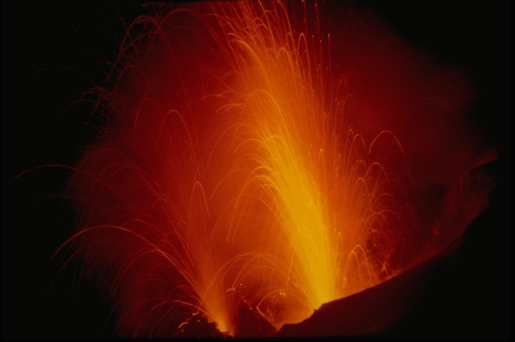 Strombolian eruptions are named after the typical eruptive style of Stromboli volcano, in Italy's Aeolian Islands.  Strombolian eruptions are characterized by repetitive moderate explosions that eject fragmental material surrounding the vent along with molten lava bombs.  The trajectories of individual incandescent bombs form parabolic arcs in time-lapse photographs. Copyrighted photo by Katia and Maurice Krafft.