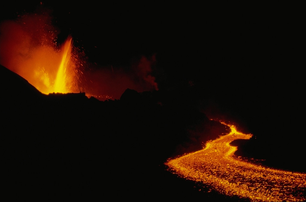 An eruption began on December 25, 1981 from a 1.5-km-long fissure at 2070 m elevation about 7 km SE of the summit caldera of Nyamuragira.  Lava fountains were soon confined to the lower end of the fissure.  This January 9, 1982 photo shows lava fountaining at the vent, which is feeding a lava flow that traveled 26 km down the NE flank.  This marked the longest historical lava flow of Nyamuragira.  Tephra fall destroyed vegetation, resulting in the death of cattle and animals, although no villages were damaged.  The eruption ended on January 14.  Copyrighted photo by Katia and Maurice Krafft, 1982.