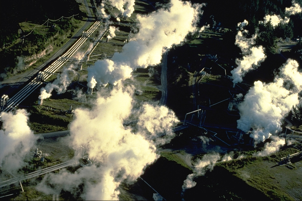 Steam rises from a geothermal plant in the Maroa caldera.  The 16 x 25 km caldera formed sometime after 230,000 years ago in the NE corner of the larger Whakamaru caldera.  The Maroa caldera was filled by at least 70 rhyolitic lava domes and flows.  The latest dated eruption took place about 14,000 years ago at Puketarata.  Large hydrothermal explosions have occurred during the Holocene, most recently about 1800 years ago at the time of a major eruption at the neighboring  Taupo volcanic centre. Copyrighted photo by Katia and Maurice Krafft, 1986.