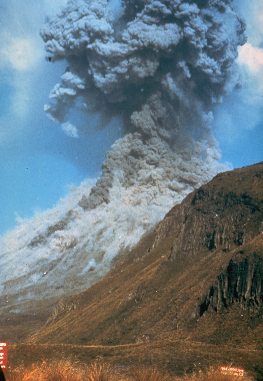 Pyroclastic flows traveling down the flanks of Ngauruhoe volcano on 19 February 1975 as an ash plume rises above the summit crater. The eruption column rose 12 km above the vent and ash fell 160 km away in Hamilton City. Explosive activity had begun on the 12th and continued until the 23rd. Photo by Graham Hancocks, 1975 (New Zealand Geological Survey).