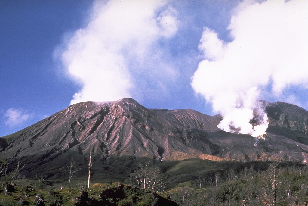 Langila, one of the most active volcanoes of New Britain, consists of a group of four small overlapping cones on the lower eastern flank of the extinct Talawe volcano. Plumes are shown here on 4 September from Craters 2 (left) and 3 (right) during a 1970 eruption. Frequent mild-to-moderate explosive eruptions, sometimes accompanied by lava flows, have been recorded since the 19th century from the three active craters at the summit. Photo by Wally Johnson, 1970 (Australia Bureau of Mineral Resources).
