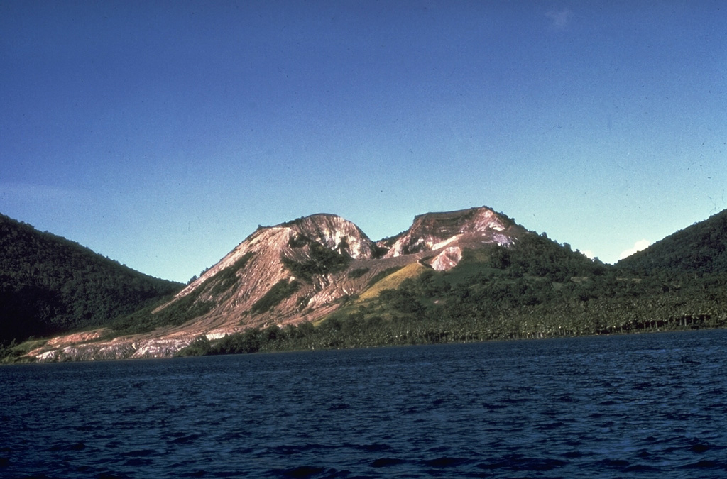 Tavurvur, seen here from the SW on a boat in Matupit Harbor, is one of several post-caldera cones constructed along the NE margin of Rabaul caldera. The cone has an irregular crater rim with a low point on the SW side; its summit and flanks have several overlapping craters. Tavurvur has been the most active of Rabaul's volcanoes, with recorded eruptions since the 18th century. Tavurvur erupted simultaneously with Vulcan on the SW side of the caldera in 1937 and again in 1994. Photo by Wally Johnson, 1970 (Australia Bureau of Mineral Resources).