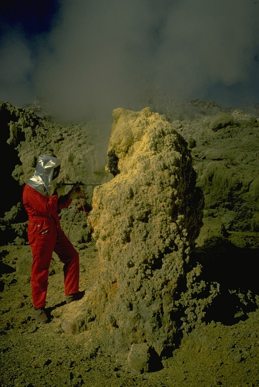Volcanologist Maurice Krafft, wearing heat-resistant headgear, measures the temperature of a sulfur-encrusted fumarole in the Kawah Mas ("Golden Crater") thermal area on Papandayan volcano. Copyrighted photo by Katia and Maurice Krafft, 1971.