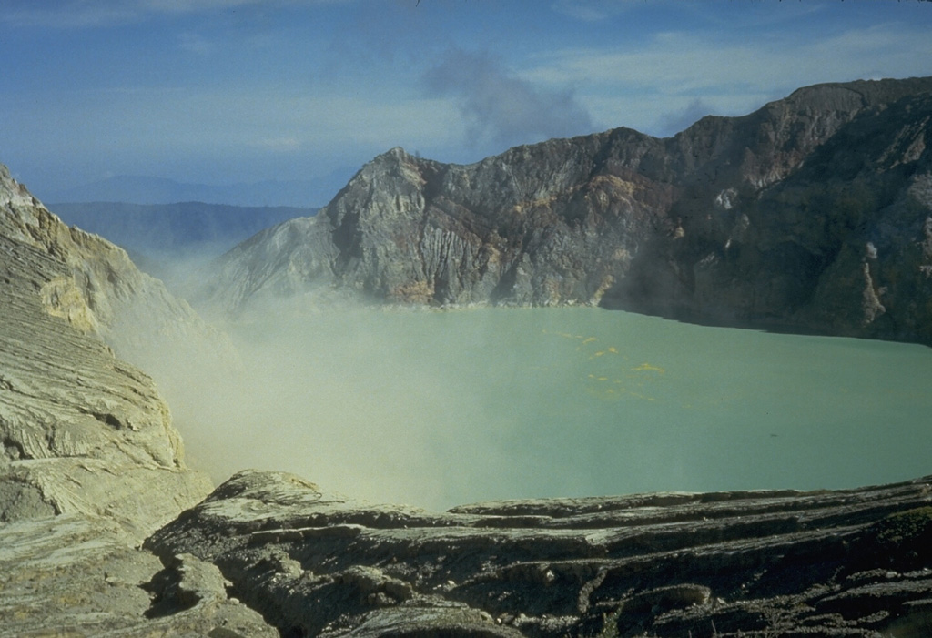 Active fumaroles on the SE crater wall of the highly acidic Kawah Ijen crater lake, within one of the cones that formed in the 20-km-wide Ijen caldera. The 1-km-wide turquoise-colored crater lake is near the eastern rim of Ijen caldera and has been the site of phreatic eruptions in historical time and is noted for its sulfur deposits.  Photo by Tom Casadevall, 1987 (U.S. Geological Survey).