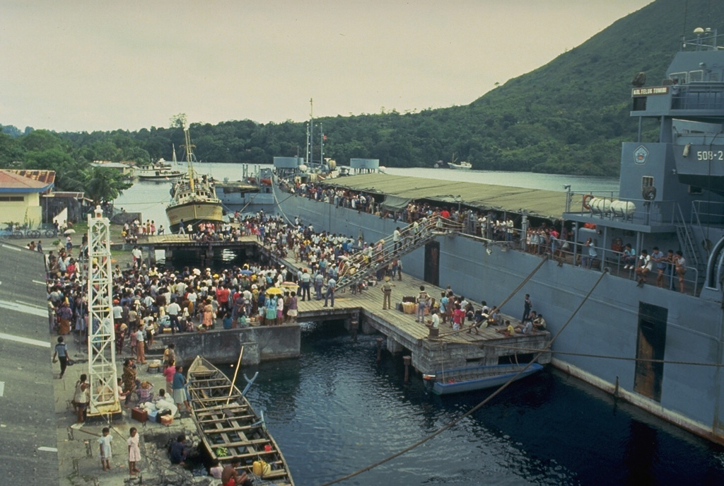 Evacuees on the island of Neira board an Indonesian Navy ship on 20 May 1988, bound for the island of Sulawesi.  About 10,000 people of a population of 16,000 living in the Banda Islands were evacuated during the 1988 eruption.  During the two days prior to the start of the eruption on the morning of 9 May, about 1800 people on Gunung Api Island (the site of the eruption) evacuated to Neira and Lonthor Islands.  On the 9th, people began moving from Neira Island to Lonthur and then to more distant locations.  The evacuation remained in effect until 13 June. Photo by Tom Casadevall, 1988 (U.S. Geological Survey).