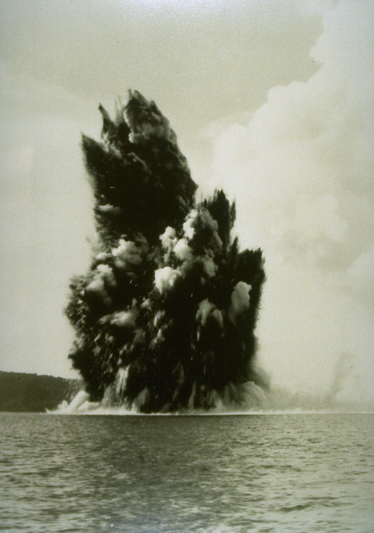 Submarine eruptions within Krakatau caldera were first observed in December 1927 and an ephemeral island appeared the following month. This 1929 view shows an ash-rich cock’s tail jet typical of shallow submarine explosions. Material ejected by earlier eruptions forms an island visible to the left. By August 1930 Anak Krakatau became a permanent island. Photo by C.E. Stehn, 1929 (courtesy Volcanological Survey of Indonesia).