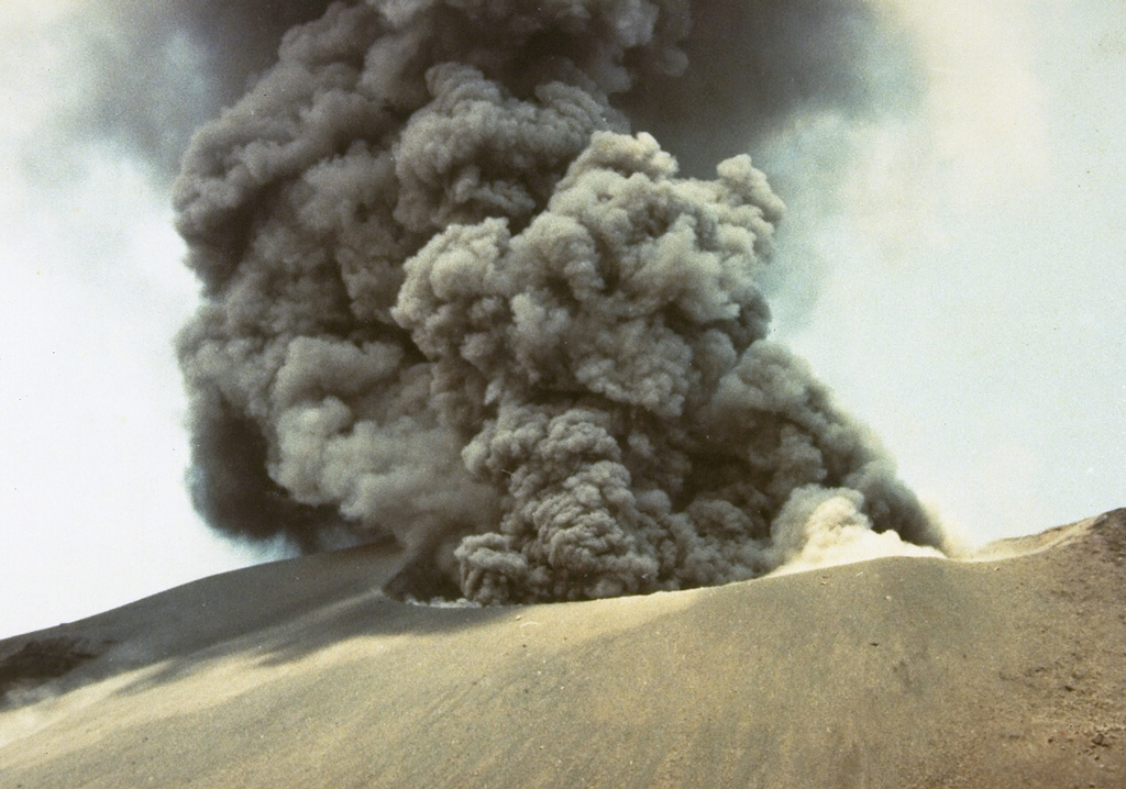 Explosive eruptions, such as this one in October 1978, occurred at Anak Krakatau from July to November. Initially, explosions occurred at intervals of 15-30 minutes, decreasing to intervals of 30-60 minutes in October before the eruption ended in November. Photo by J. Matahelumual, 1978 (Volcanological Survey of Indonesia).