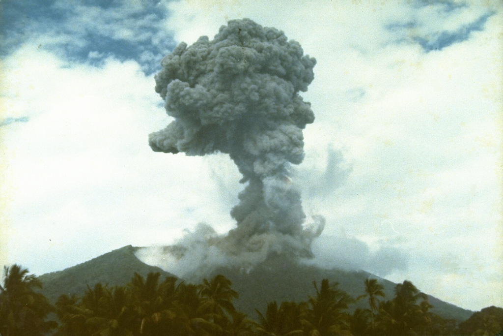 An eruption plume, viewed from the north, rises from the summit of Soputan volcano on September 13, 1982.  The eruption began on August 26, when an eruption column rose 15 km, and lasted until November 10.  The August 26 explosion prompted the evacuation of 850 inhabitants of a village on the flank of the volcano. Photo by Ruska Hadian, 1982 (Volcanological Survey of Indonesia).