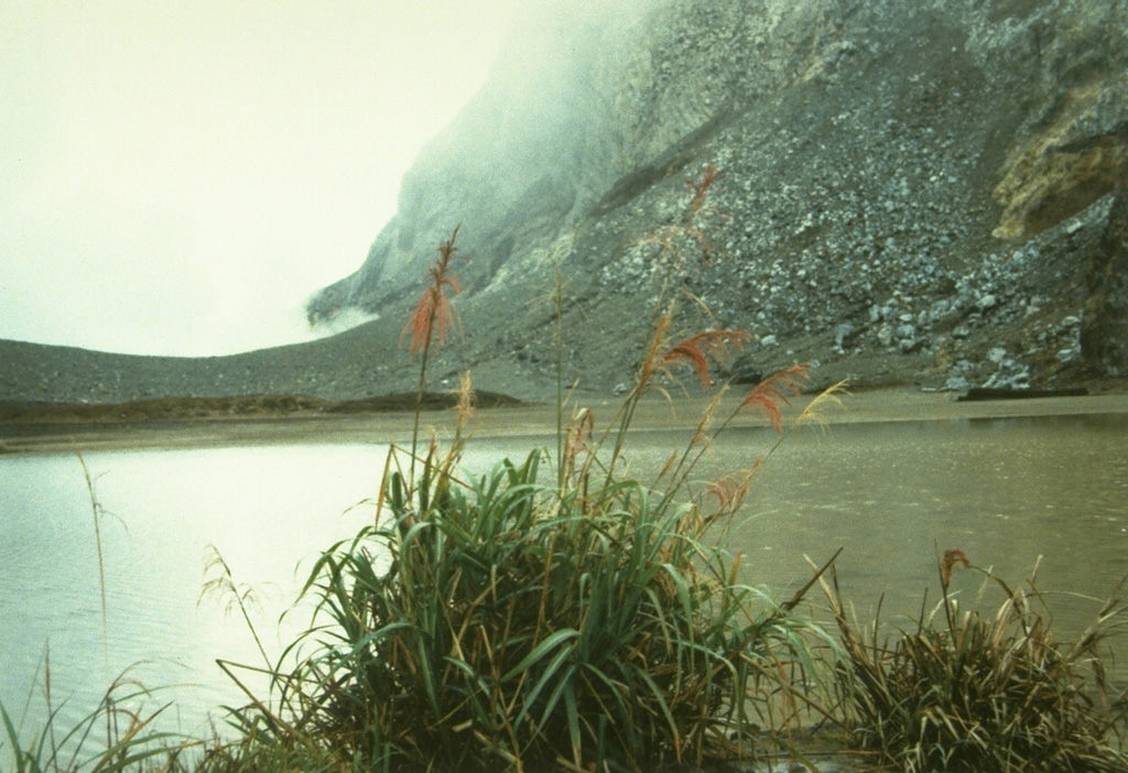 Gamkonora volcano on Halmahera Island contains a summit crater elongated in a N-S direction that has been the source of historical eruptions since the 16th century.  A small 100 x 150 m crater lake occurs at the north end of the summit crater complex. Photo by A. Solihin, 1984 (Volcanological Survey of Indonesia).