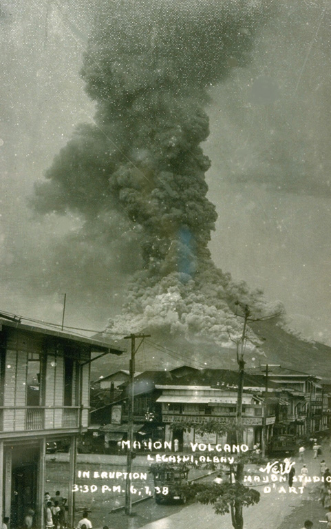 This commercial print of an eruption of Mayon volcano on June 7, 1938, shows a powerful vertical eruption column rising above the summit and pyroclastic flows sweeping down the flanks.  During this eruption a lava flow traveled down the east flank to 570 m elevation, and shorter lava flows descended the SSW, west, NW, and NNE flanks. From the collection of Maurice and Katia Krafft.