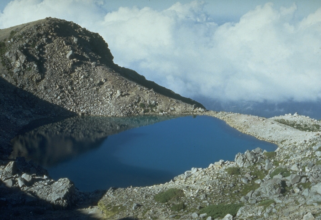 Midorigaike, seen here from the SW, is one of several craters along the summit complex of Hakusan. A documented eruption in 1042 CE formed Midorigaike pond and buried a wooden hut near the summit. Descriptions suggest that the eruption consisted of phreatic explosions that ejected older volcanic rocks around the vent. Photo by Toshio Higashino (Haku-san Nature Conservation Center).
