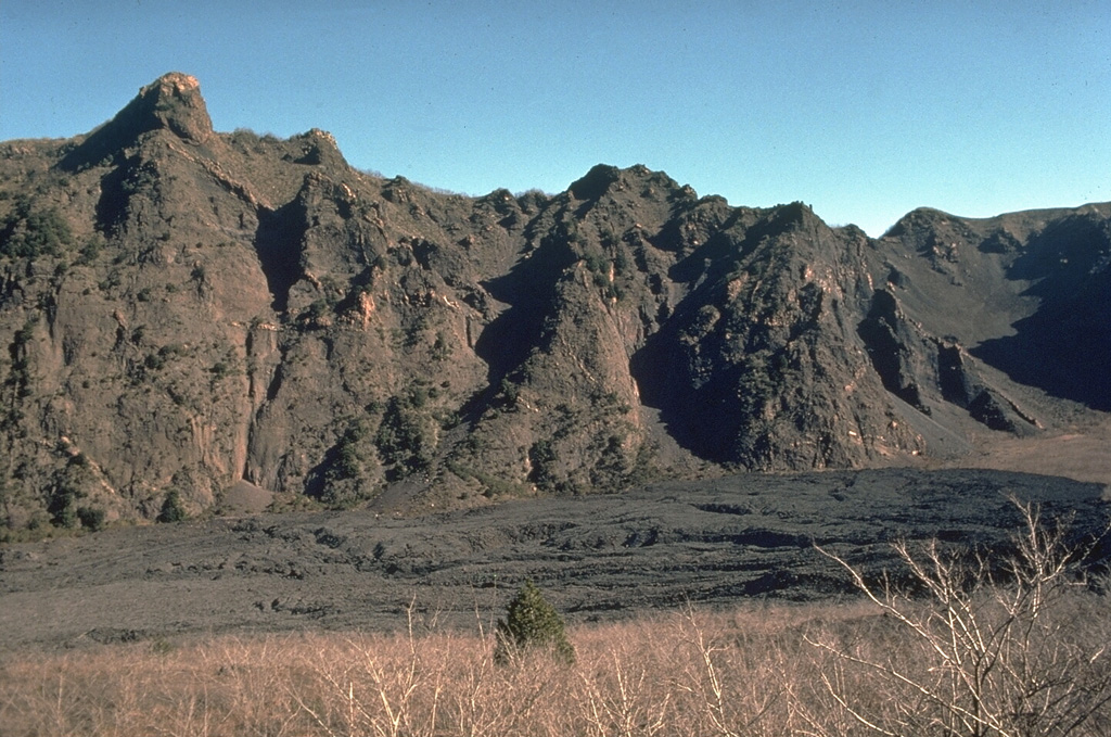 The dark-colored lava flow filling the caldera moat between the cone of Vesuvius and the caldera wall of Monte Somma in the background was produced during an eruption in 1944, near the end of the eruptive cycle that began in 1913. Photo by Roberto Scandone, 1989 (University of Rome).
