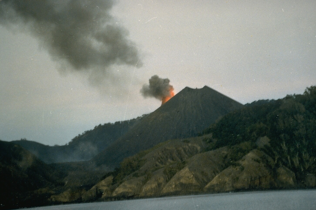 The central scoria cone of Barren Island is seen here from the SW erupting in May 1991. The 1991 eruption, the first of the 20th century from Barren Island, included explosive activity from a vent on the upper NE flank and lava flows that reached the west coast of the island.  Photo courtesy of V.K. Raina, 1991 (Geological Survey of India).