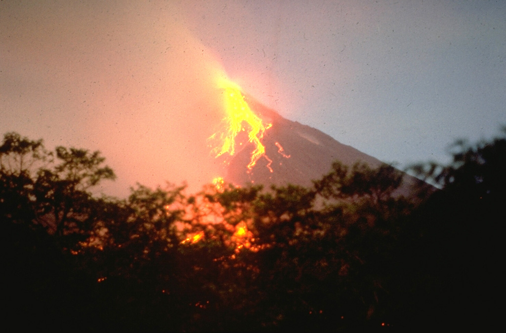 Incandescent blocks roll down the SW flanks of Mayon on 18 May 1978, seen from near Camalig on the SW flank. During the eruption a lava flow traveled a distance of more than 4 km over the top of the 1968 lava flow to about 550 m elevation. The 1978 eruption began on 7 March and continued through the summer. Photo by Chris Newhall, 1978 (U.S. Geological Survey).