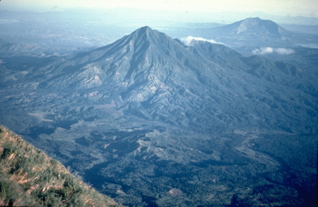 Masaraga rises NW of Mayon volcano. This view from near the summit of Mayon also shows Mount Iriga (upper right), with its large horseshoe-shaped crater.  Photo by Chris Newhall (U.S. Geological Survey).