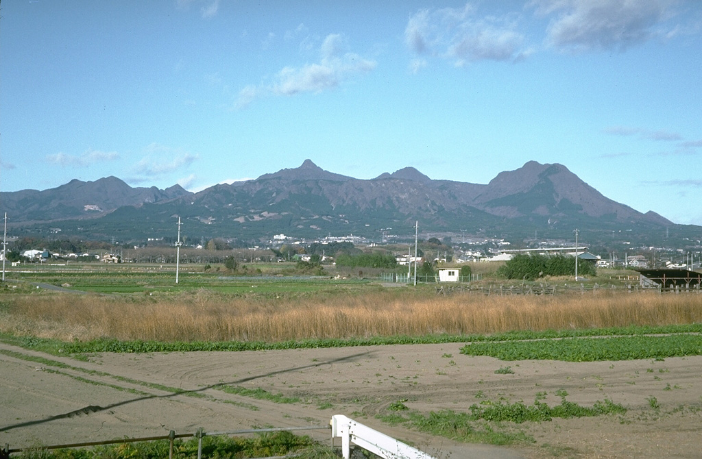 The summit of Harunasan is seen here from near Maebashi City, SE of the volcano. It contains a caldera and lava domes inside the caldera and on its rim and flanks. Futatsudake, the peak to the right, was the source of two major explosive eruptions during the 5th and 6th centuries.  Photo by Tom Simkin, 1993 (Smithsonian Institution).