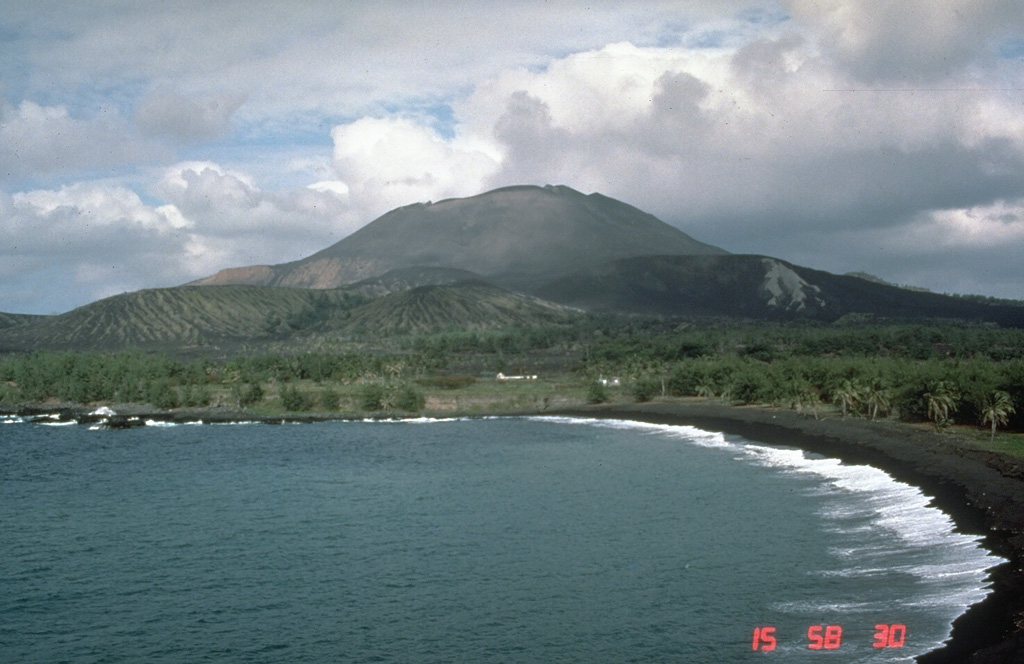 Pagan Island, the largest and one of the most active of the Mariana Islands, consists of two volcanoes connected by a narrow isthmus. Both North and South Pagan were constructed within calderas. North Pagan, the most active of the two, is seen here from the west coast of the isthmus, SW of the summit; it was constructed within a 7-km-wide caldera.  Photo by Norm Banks, 1983 (U.S. Geological Survey).