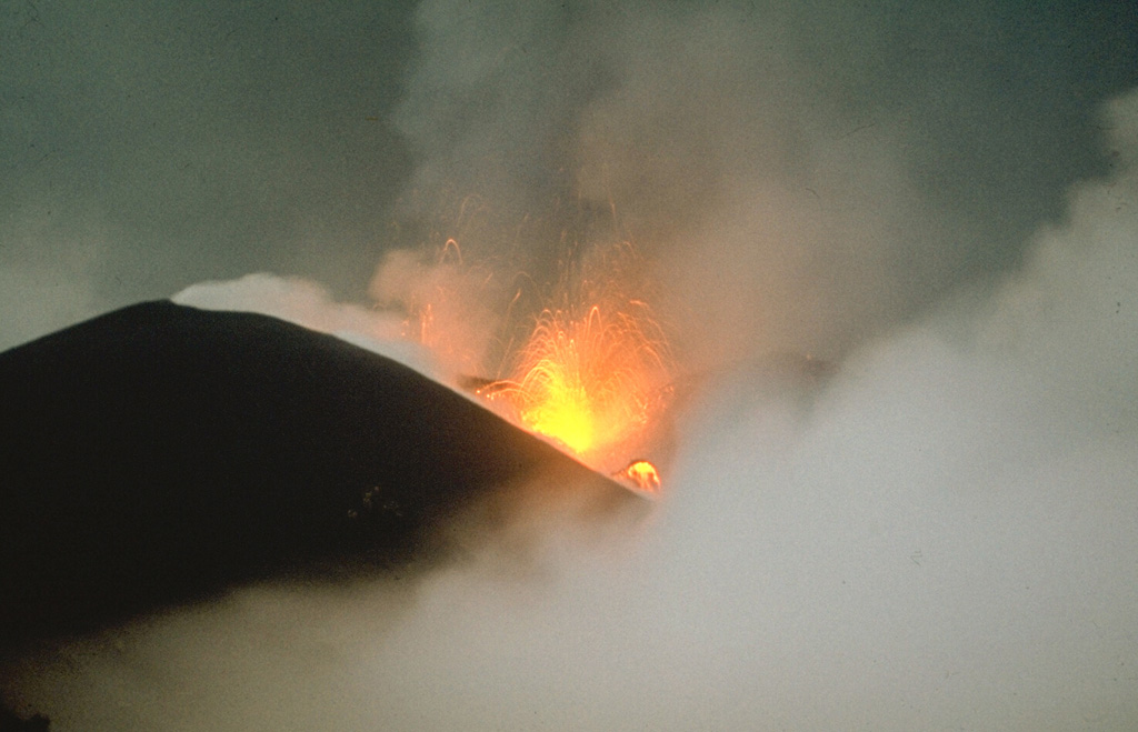 Strombolian eruptions occurred at vents along a 2-km-long fissure on the NW flank of Alaid in 1972. Explosive activity began on 18 June and was accompanied by lava extrusion beginning on the 21st. By 16 July lava flows dominated the activity, extending 1 km to the sea and forming a new peninsula. Explosive activity diminished prior to the end of the eruption on 11 September.  Photo by A.M. Chirkov, 1972 (courtesy of Oleg Volynets, Institute of Volcanology, Petropavlovsk).