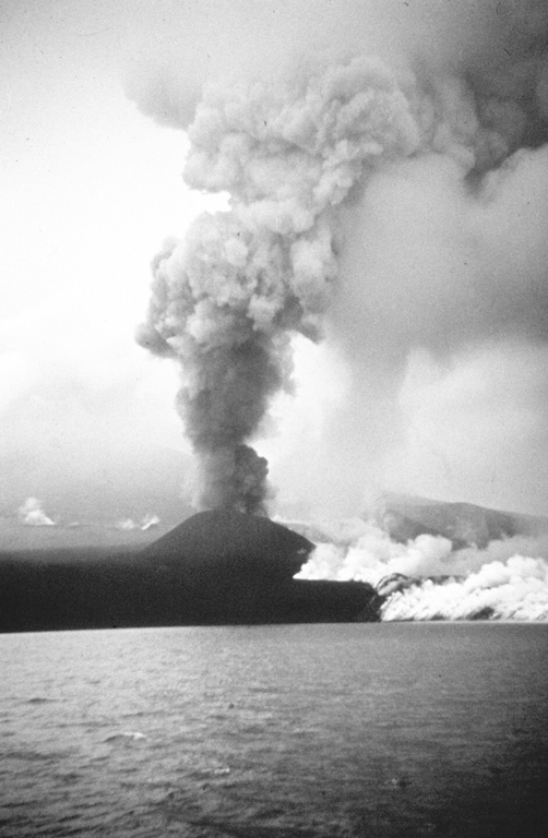 The 1972 eruption of Alaid in the northern Kuril Islands, seen here in August, was characterized by both explosive and effusive activity. An ash plume towers above a small scoria cone that formed on a 2-km-long fissure on the NW flank, while white gas-and-steam plumes rise from the margins of this lava flow that traveled 1 km into the Sea of Okhotsk. The eruption began on 18 June and ended by 11 September. Photo by A.M. Chirkov, 1972 (courtesy of Oleg Volynets, Institute of Volcanology, Petropavlovsk).