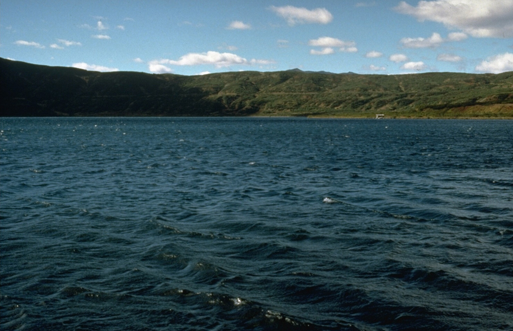 The 3 x 5 km lake-filled Akademia Nauk caldera formed during the late Pleistocene within an earlier caldera. The caldera was active during the Holocene, low-temperature geothermal activity took place along the shores of the caldera lake, and an eruption took place in 1996. Photo by Dan Miller, 1990 (U.S. Geological Survey).