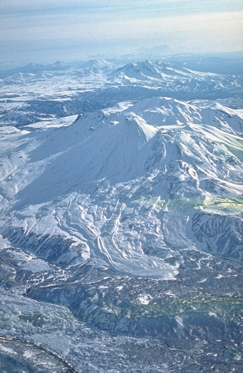 Kikhpinych is located E of the Uzon caldera and has three edifices, the youngest of which are the central, Zapadny, and Savich (left center) cones. Numerous young lava flows have been emplaced on the flanks of the Savich cone, seen here from the NE. Savich erupted 400 years ago, forming the Krab lava dome formed on its eastern flank. Photo by Oleg Volynets (Institute of Volcanology, Petropavlovsk).
