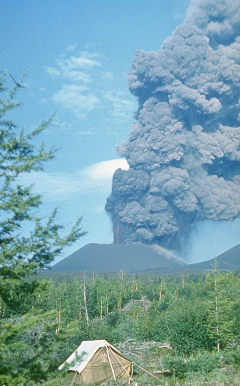 An ash plume rises above a scoria cone along the S-flank rift zone of Kamchatka's Tolbachik volcano in late July 1975. This was the first of three cones formed along the northern part of the rift zone during the early stage of the eruption and was only a few weeks old at the time of this photo. Lava fountains rose 1-2.5 km above the vent and ash plumes reached 10-18 km heights. Photo by Oleg Volynets, 1975 (Institute of Volcanology, Petropavlovsk).