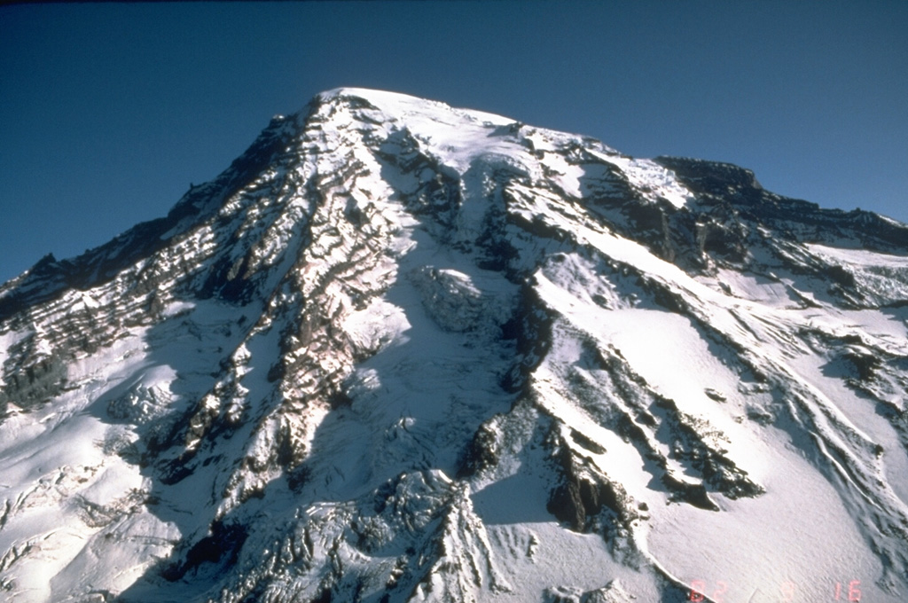 Stratovolcanoes, also referred to as composite volcanoes, are constructed of sequential layers of resistant lava flows and fragmented rock produced by explosive eruptions. An aerial view of the glacially dissected SW flank of Mount Rainier shows the layered interior of a stratovolcano. Photo by Dan Dzurisin, 1982 (U.S. Geological Survey).