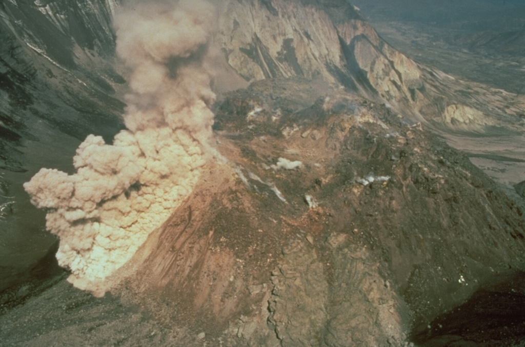 An ash plume rises above a rockfall on the south side of the Mount St. Helens dome during a period of lava dome growth in June 1985. Lava dome growth occurred intermittently from 1980 to 1986. Photo by Gene Iwatsubo, 1985 (U.S. Geological Survey).