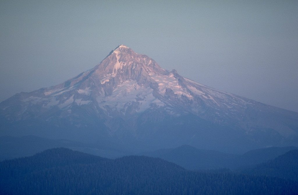Mount Hood, seen here from Larch Mountain on the NW side, is a recently active volcano in Oregon. A major eruptive period occurred in the late 1700s, and 19th-century Pacific Northwest tribes and settlers observed minor eruptions. Photo by Lee Siebert, 1980 (Smithsonian Institution).