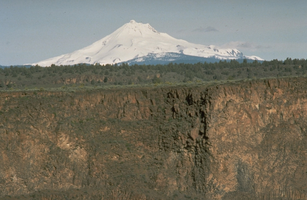 Mount Jefferson of the central Oregon Cascades rises above deep canyons eroded into thick lava flows of the Columbia River Basalt formation that covers a large area to the NE.  Photo by Richard Waitt, 1984 (U.S. Geological Survey).