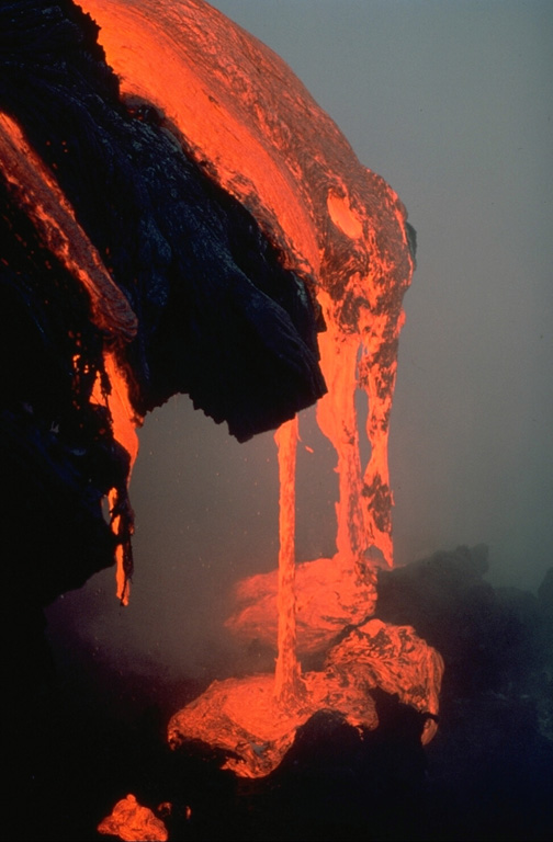 A lava flow drips into the sea, a common sight during the long-term eruption from Kilauea's east rift zone that began in 1983.  This closeup view was taken in May 1987. Copyrighted photo by Katia and Maurice Krafft, 1987.