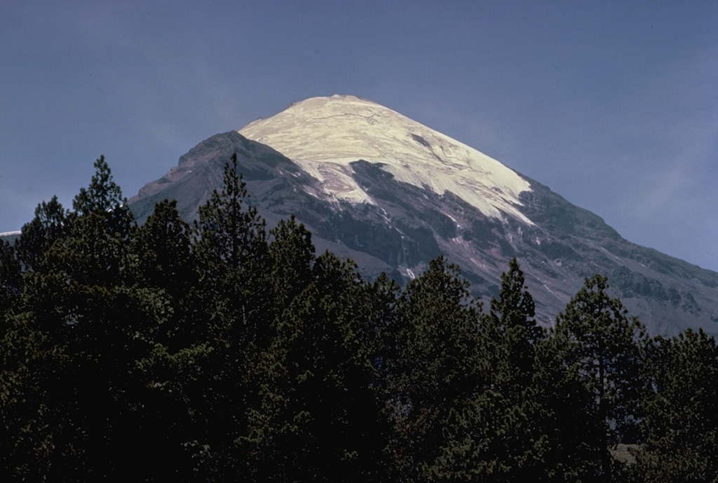 Pico de Orizaba (Volcán Citlaltépetl) rises to 5675 m at the southern end of volcanic chain the extends north to Cofre de Perote volcano.  Orizaba is seen here from its NW flank with the snow-free peak of Sarcofago halfway down the left skyline.    Periodic major explosions during the Holocene from North America's highest volcano were separated by long quiescent periods.  Eruptions during the past 5000 years have primarily produced dacitic lava flows.  Historical activity has consisted of minor ash eruptions and the extrusion of viscous lava flows. Copyrighted photo by Katia and Maurice Krafft, 1978.