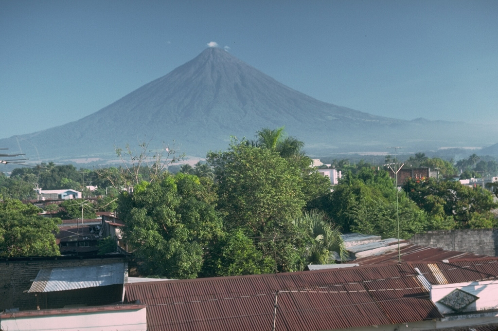Volcán de Agua rises above the city of Escuintla, which underlies a massive debris avalanche deposit from the Fuego-Acatenango massif, out of view to the left.  Photo by Lee Siebert, 1988 (Smithsonian Institution).