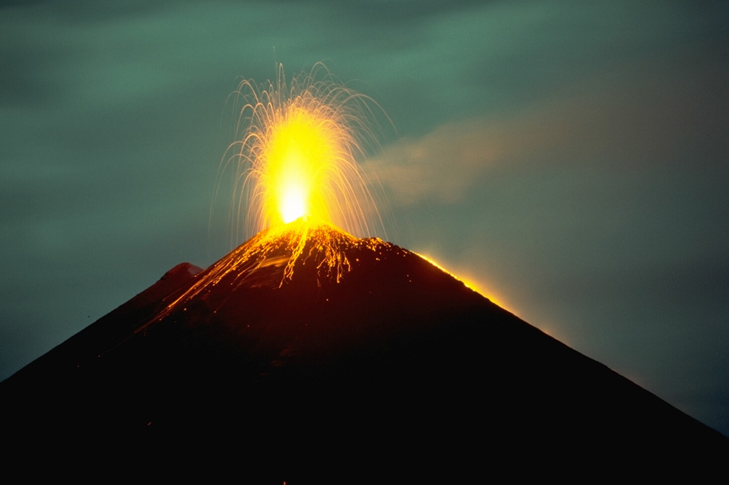 A period of Strombolian activity began at Pacaya in 1965 and continued for over 25 years. Nighttime explosions are often visible from Guatemala City, 40 km N. The accumulation of ejecta from frequent explosions periodically increases the height of MacKenney cone after it has been partially destroyed by intermittent larger explosions. This November 1988 photo also shows a lava flow descending the west flank (right). Photo by Lee Siebert, 1988 (Smithsonian Institution).