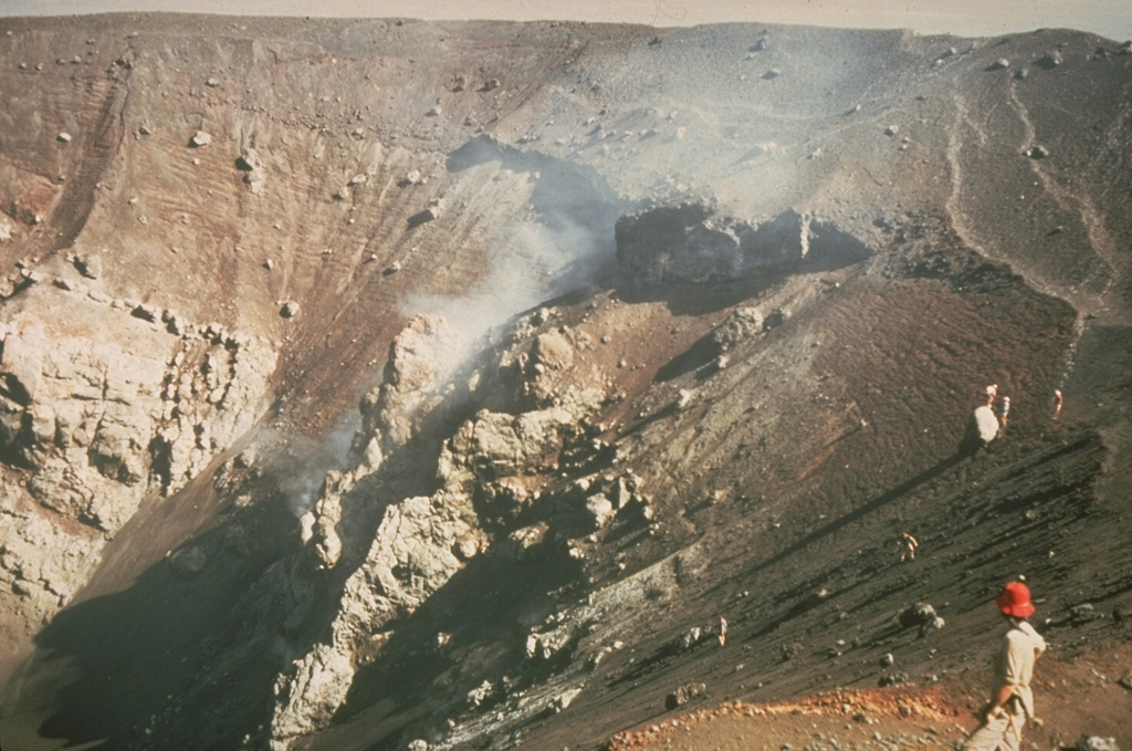 A geologist surveys the enlarged crater of Cerro Negro volcano in December 1972, observing the effects of the previous eruption during February 3-14, 1971.  Powerful explosions substantially enlarged the summit crater from 150 m in diameter before the eruption to 400 m after it.  This highly explosive eruption produced ashfall that caused extensive crop damage over a 5000 km2 area. Photo by Dennis Nielson, 1972 (courtesy of Mike Carr, Rutgers University).