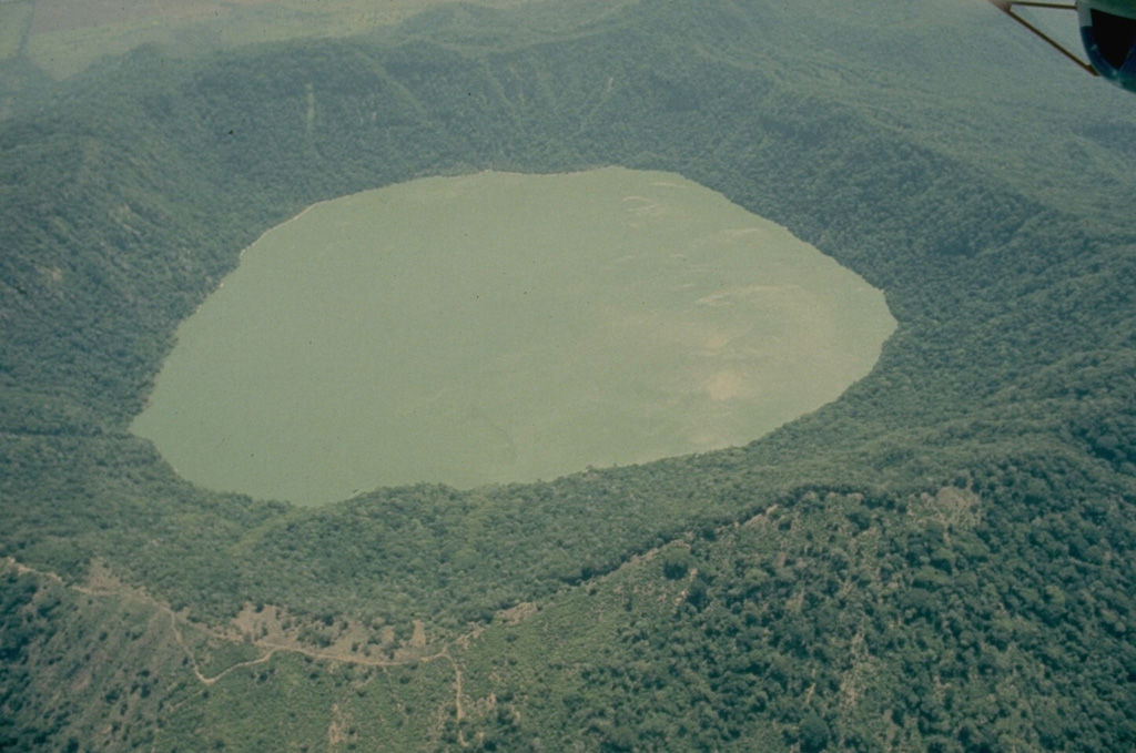 The forested Apoyeque stratovolcano is truncated by a 2.8-km-wide lake-filled caldera, seen here from the west.  Another lake-filled caldera, Laguna de Jiloa, is located immediately to the SE. Photo by Jaime Incer, 1975.