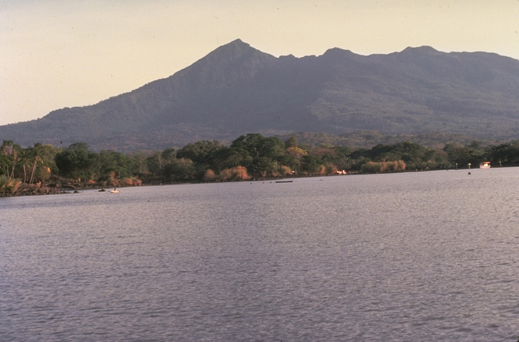 Mombacho is a stratovolcano on the shores of Lake Nicaragua that has undergone edifice collapse on several occasions. The NE-flank scarp was the source of a large debris avalanche that produced an arcuate peninsula and the Las Isletas chain of islands in Lake Nicaragua. The only reported historical activity was in 1570, when a debris avalanche destroyed a village on the S side of the volcano. Photo by Jaime Incer, 1977.