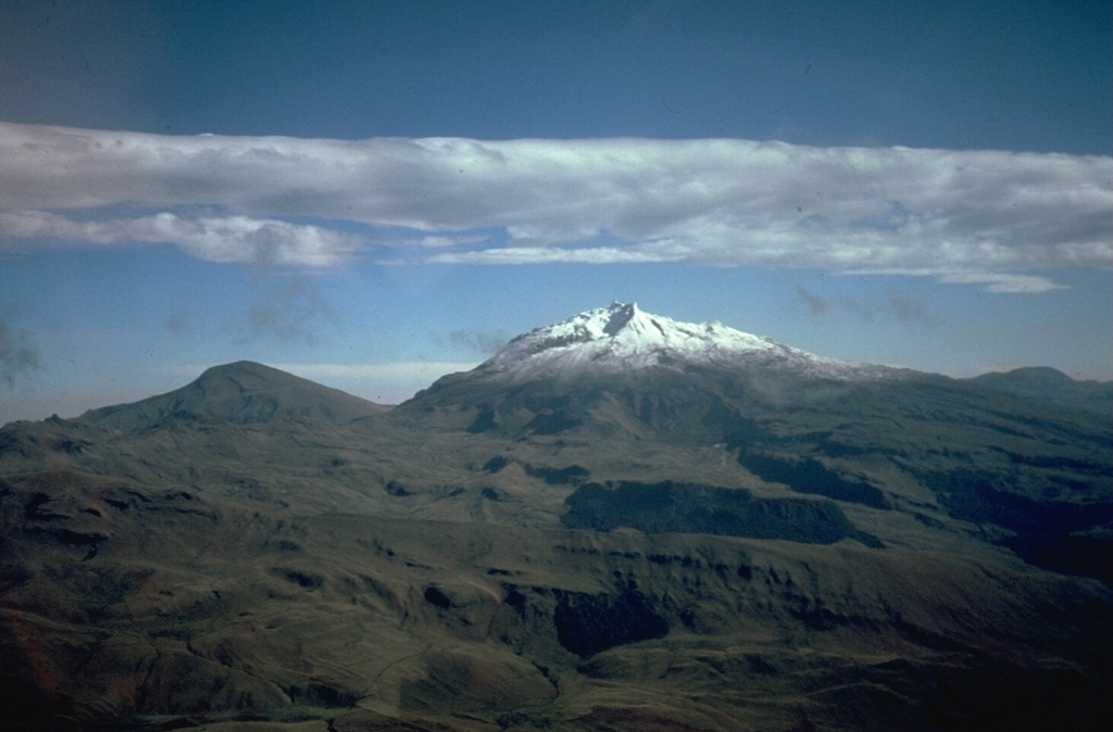 Cerro Negro de Mayasquer (Ieft) and snow-capped Volcán Chiles (right), seen here from the south, are twin volcanoes that straddle the Colombia-Ecuador border.  Chiles volcano is of Pleistocene age, but has hot springs and an active hydrothermal system on its eastern flank.  Cerro Negro de Mayasquer is a stratovolcano with a caldera open to the west.  Andesitic and dacitic lava flows are of possible Holocene age.  Solfataras are found on the shore of a small crater lake.  Photo by Minard Hall, 1985 (Escuela Politécnica Nacional, Quito)