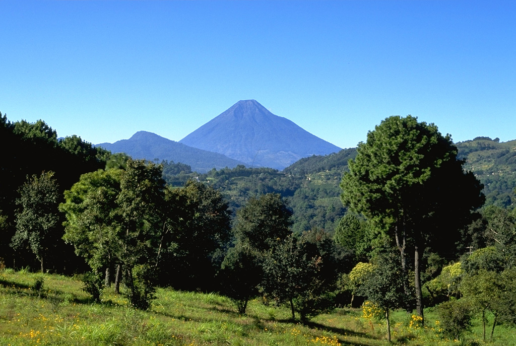 Volcán de Agua is one of Guatemala's prominent stratovolcanoes. Seen here from the north, the breached summit crater is visible. Copyrighted photo by Stephen O'Meara, 1993.
