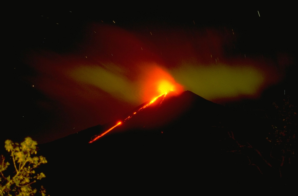 An incandescent lava flow from Pacaya is seen here moving down the SW flank with Strombolian explosions from the summit crater in November 1994. Copyrighted photo by Stephen O'Meara, 1994.